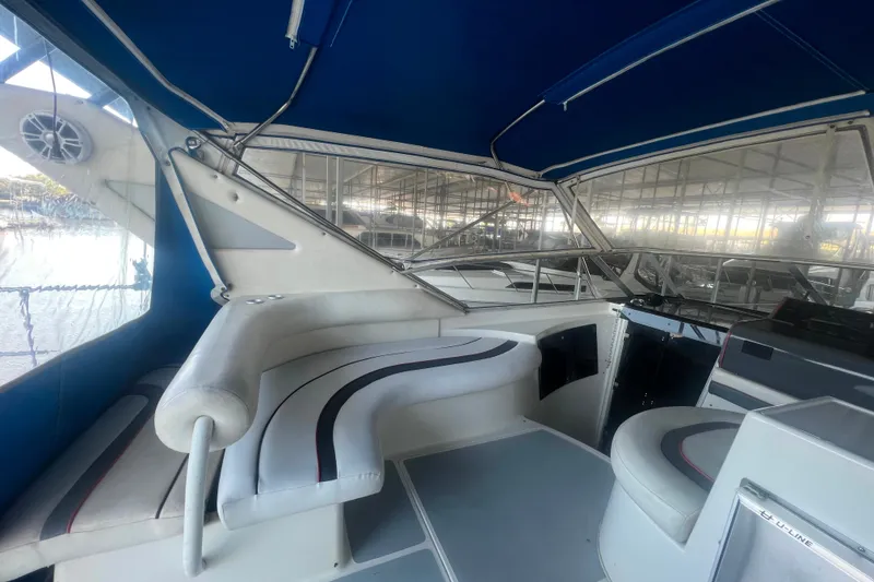 Slide: The Image of 1989 Bayliner 4285 Avanti interior with curved seating and table. - 23