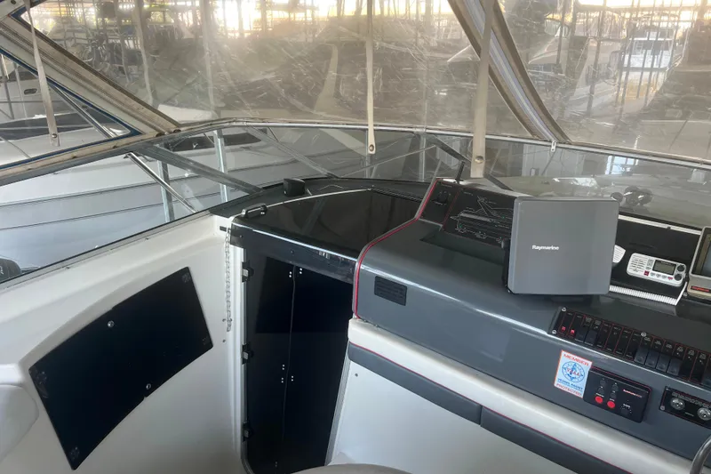 Slide: The Image of 1989 Bayliner 4285 Avanti cabin interior with bed, portholes, and cozy lighting. - 26