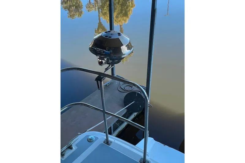 Slide: The Image of 1989 Bayliner 4285 Avanti boat with a mounted grill by the water. - 35