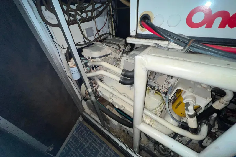 Slide: The Image of Engine compartment of 1989 Bayliner 4285 Avanti, featuring Onan generator and complex wiring. - 37