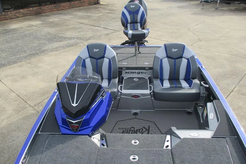 Slide: The Image of 2026 Ranger Z519 Cup-Equipped boat interior with blue and gray seating. - 12