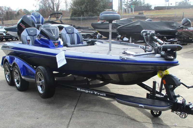 Slide: The Image of 2026 Ranger Z519 Cup-Equipped boat, blue and gray, on a trailer in a parking lot. - 5