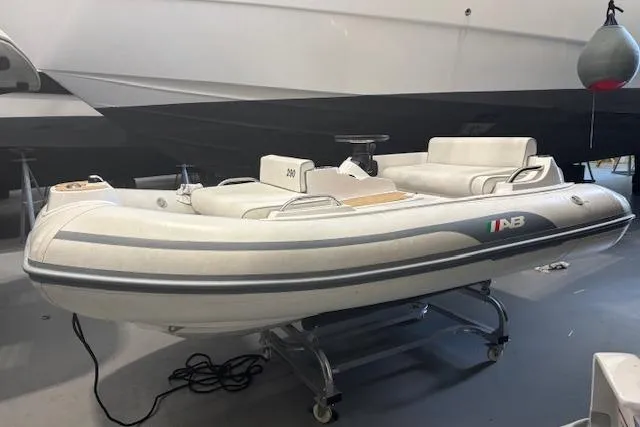 Slide: The Image of 2023 AB Inflatables ABJET 290 boat in showroom, sleek design, white and gray color scheme. - 13