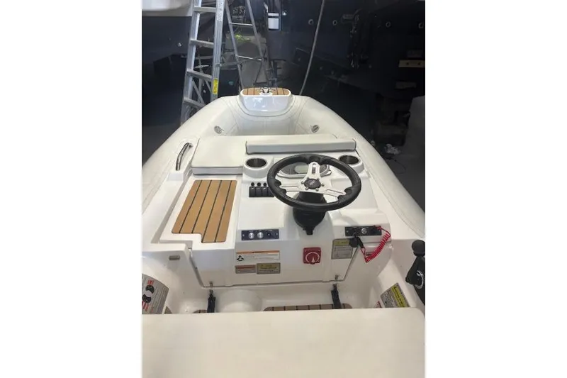 Slide: The Image of 2023 AB Inflatables ABJET 290 boat interior with steering wheel and control panel. - 9