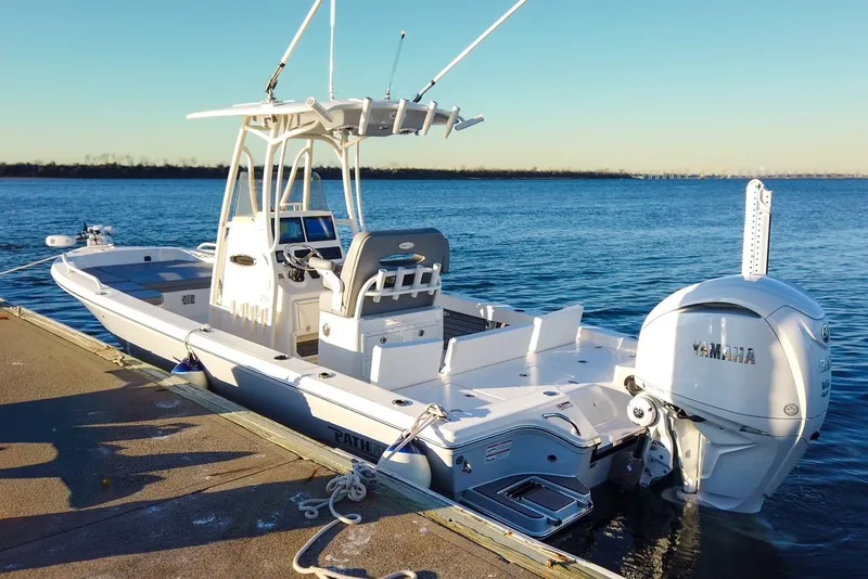 Slide: The Image of 2024 Pathfinder 2600 TRS boat docked with Yamaha engine. - 14