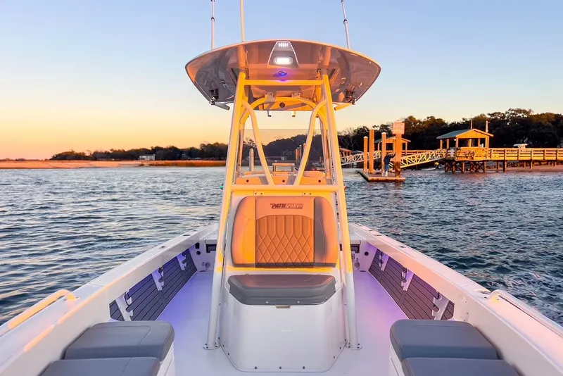 Slide: The Image of 2024 Pathfinder 2600 TRS boat at sunset on the water. - 16