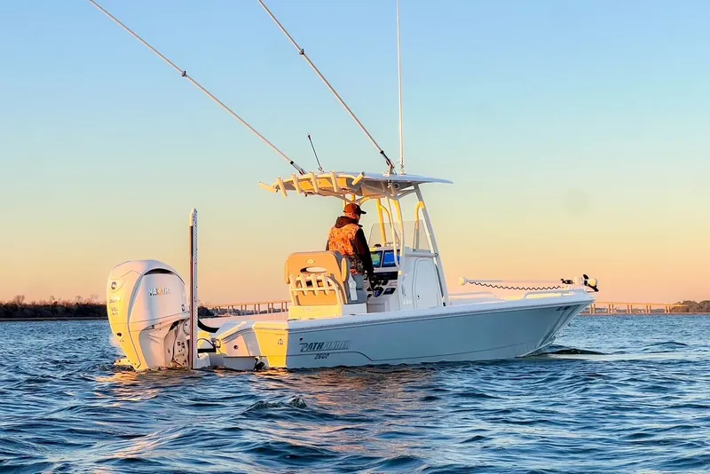 Slide: The Image of 2024 Pathfinder 2600 TRS boat on calm water at sunset. - 2