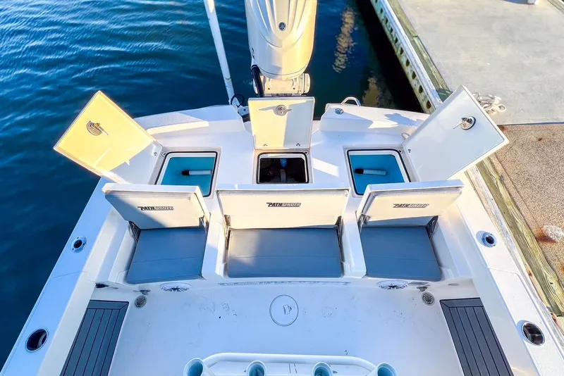 Slide: The Image of 2024 Pathfinder 2600 TRS with open storage compartments at dock. - 33