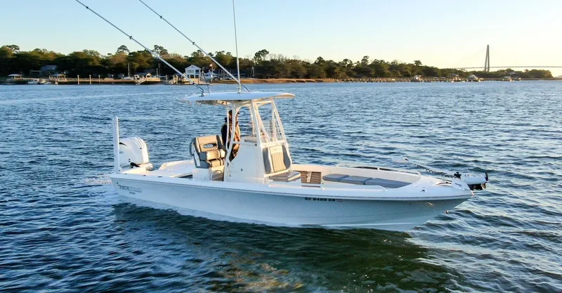 Slide: The Image of 2024 Pathfinder 2600 TRS boat on calm water at sunset. - 4