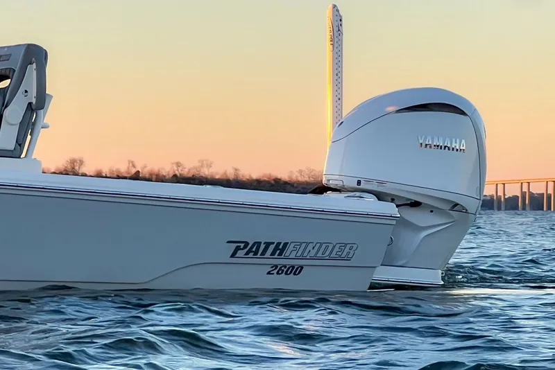 Slide: The Image of 2024 Pathfinder 2600 TRS boat on calm water at sunset. - 46