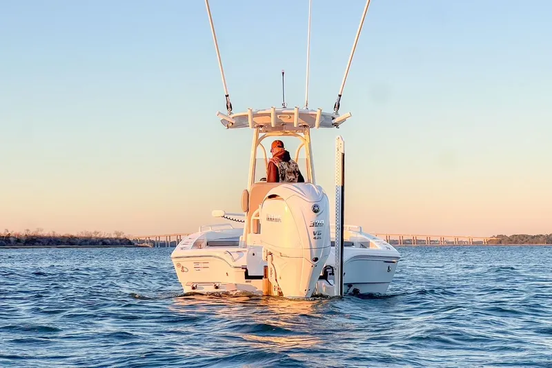 Slide: The Image of 2024 Pathfinder 2600 TRS boat on calm water at sunset. - 6