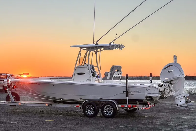 Slide: The Image of 2024 Pathfinder 2600 TRS boat at sunset by the water. - 9