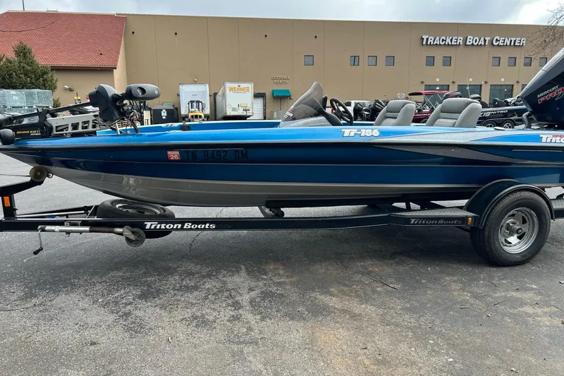 Slide: The Image of 2006 Triton Tr-186 SC blue boat on trailer at Tracker Boat Center. - 4