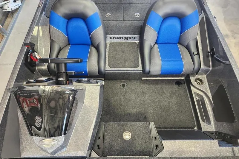 Slide: The Image of 2026 Ranger Z185 boat interior with blue and gray seats, steering wheel, and console. - 12