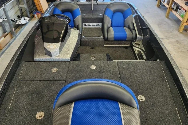 Slide: The Image of 2026 Ranger Z185 boat interior with blue and gray seating, spacious layout, and modern design. - 13
