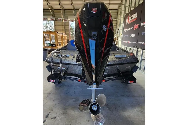 Slide: The Image of 2026 Ranger Z185 boat in a garage, showcasing its powerful outboard motor. - 3