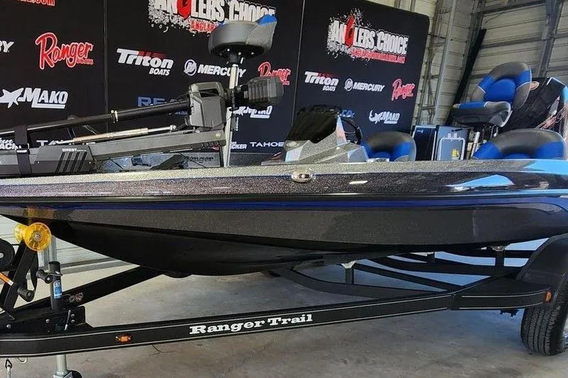 Slide: The Image of 2026 Ranger Z185 boat on display with branded backdrop and seating. - 4