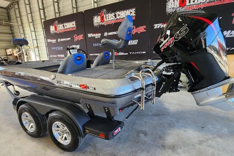 Slide: The Image of 2026 Ranger Z185 boat with dual axle trailer and powerful outboard motor in showroom. - 5