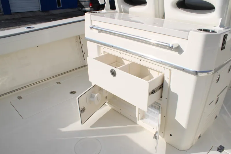 Slide: The Image of 2026 Cobia 285 Center Console boat interior with open storage compartments. - 13