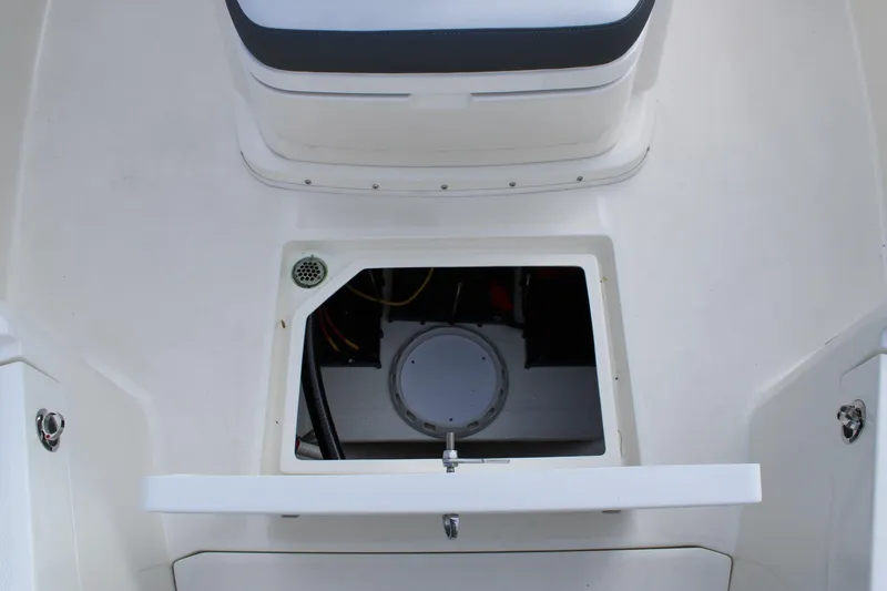 Slide: The Image of 2026 Cobia 285 Center Console boat storage compartment with open hatch. - 23