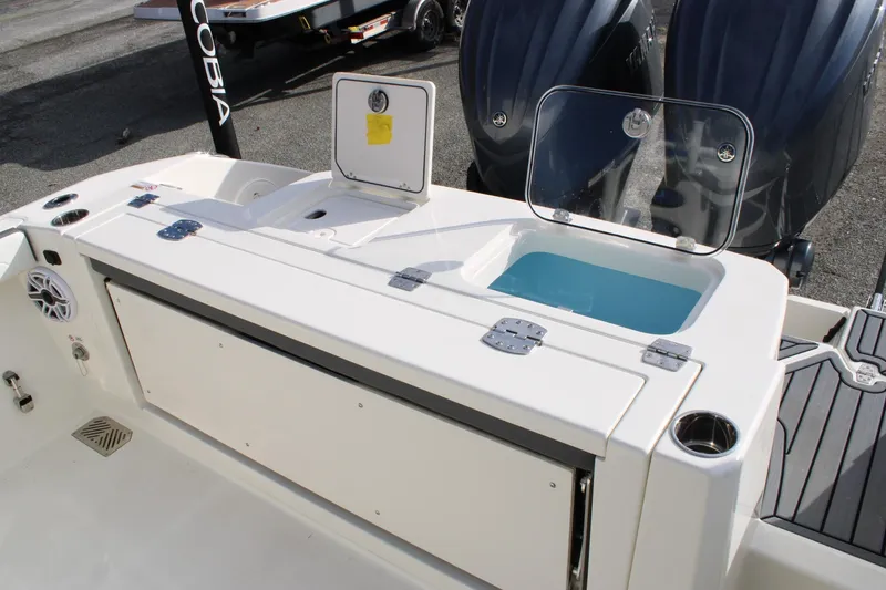 Slide: The Image of 2026 Cobia 285 Center Console boat with dual engines and livewell. - 29