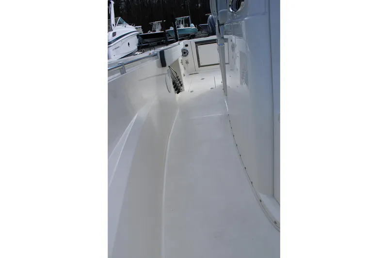 Slide: The Image of 2026 Cobia 285 Center Console boat deck, showcasing sleek design and spacious walkway. - 32