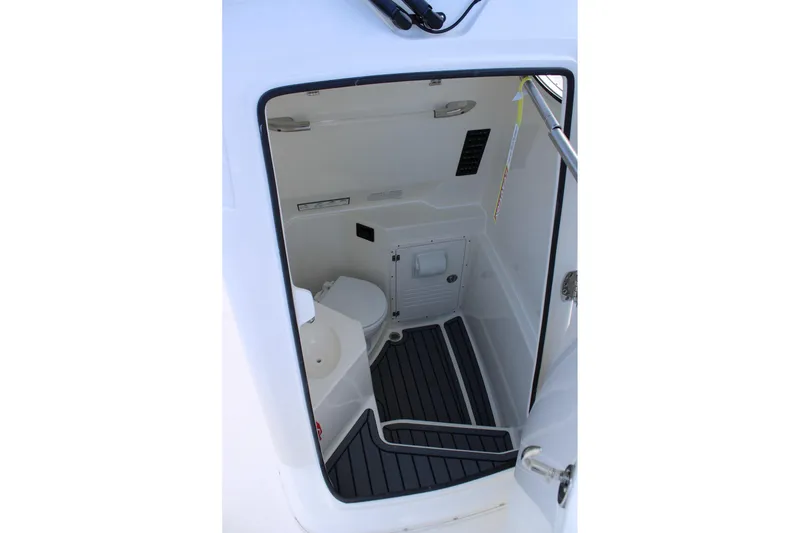 Slide: The Image of 2026 Cobia 285 Center Console boat interior with compact restroom facilities. - 34