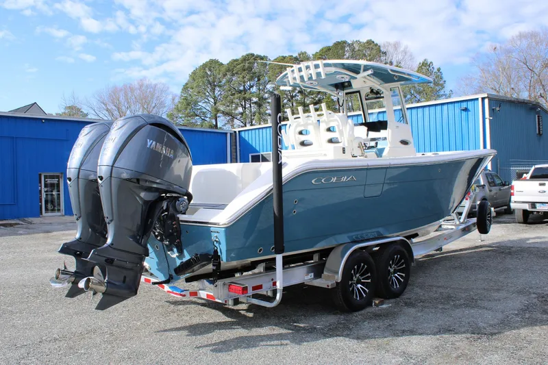 Slide: The Image of 2026 Cobia 285 Center Console boat on trailer with dual Yamaha engines. - 4