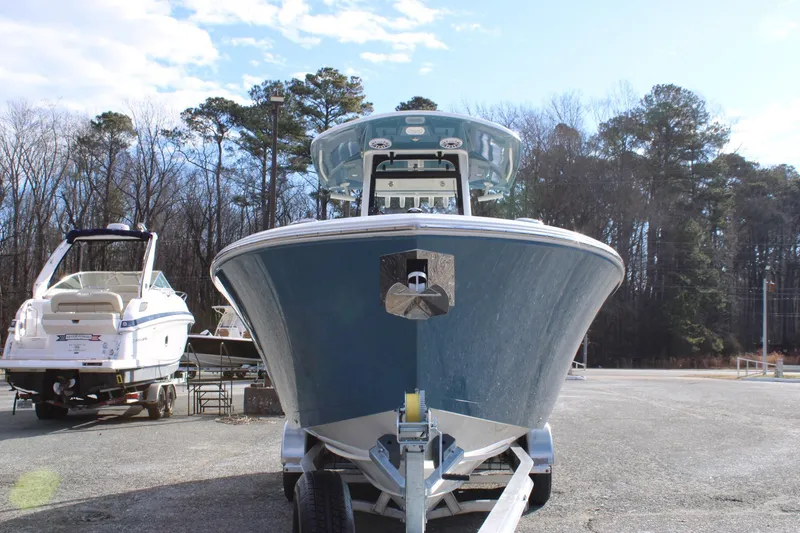 Slide: The Image of 2026 Cobia 285 Center Console boat on trailer, parked outdoors. - 7