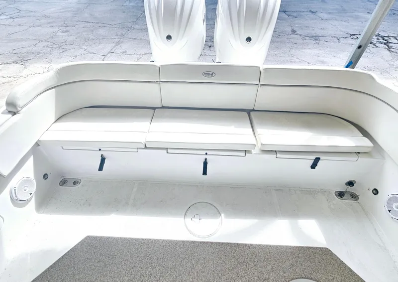 Slide: The Image of 2023 Sea Hunt Escape 28 boat with dual engines docked by the water. - 11