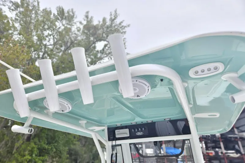 Slide: The Image of 2023 Sea Hunt Escape 28 boat with a YETI cooler in storage compartment. - 16