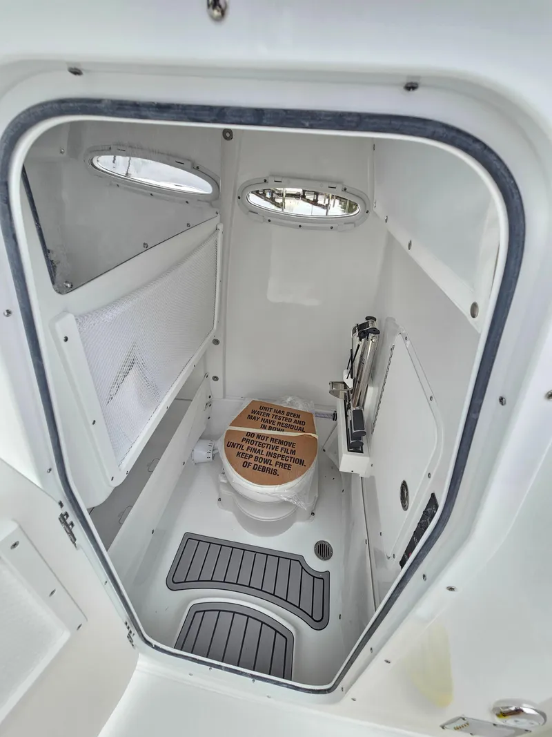 Slide: The Image of 2023 Sea Hunt Escape 28 boat storage with glass holders and stainless steel containers. - 18