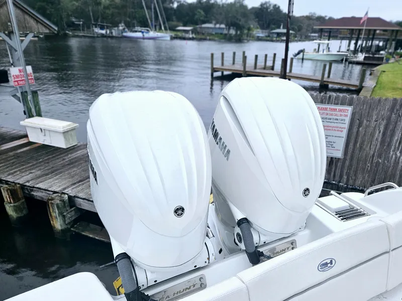 Slide: The Image of 2023 Sea Hunt Escape 28 boat interior with comfortable seating and dual engines. - 19