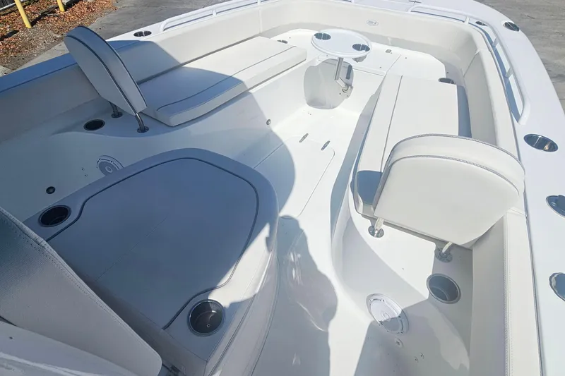 Slide: The Image of 2023 Sea Hunt Escape 28 boat interior with white seating and cup holders. - 28