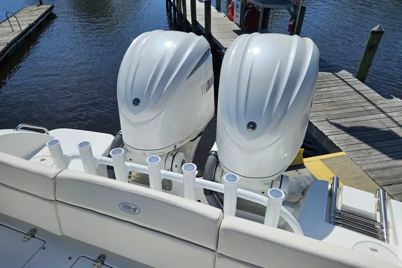 Slide: The Image of 2023 Sea Hunt Escape 28 with dual outboard engines at dockside. - 34