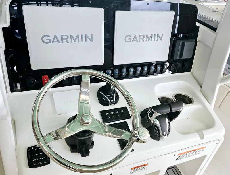 Slide: The Image of 2023 Sea Hunt Escape 28 boat with rod holders and Yamaha engine detail. - 4