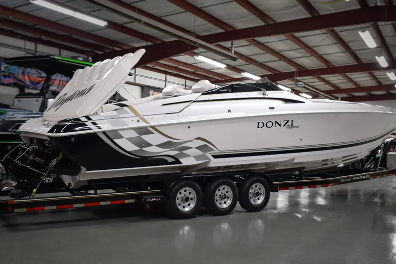 Slide: The Image of 2002 Donzi 38 ZX speedboat on trailer in indoor showroom. - 1