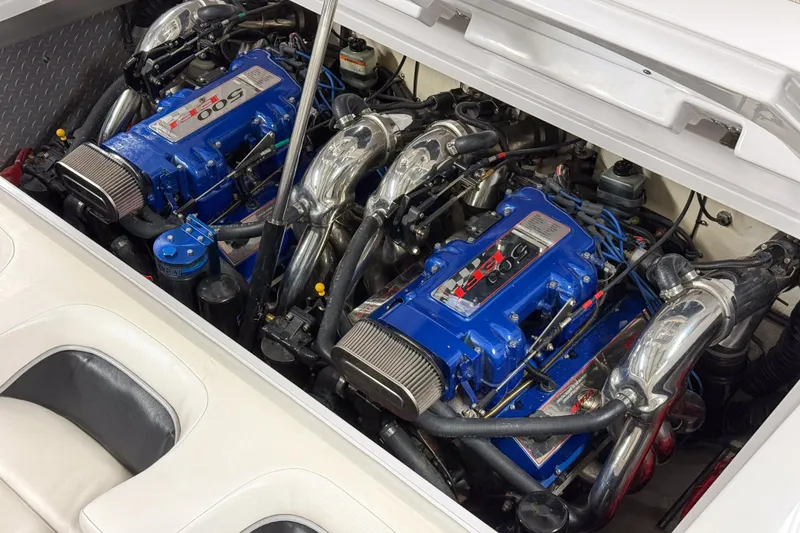 Slide: The Image of 2002 Donzi 38 ZX boat engine compartment with twin blue high-performance engines. - 10