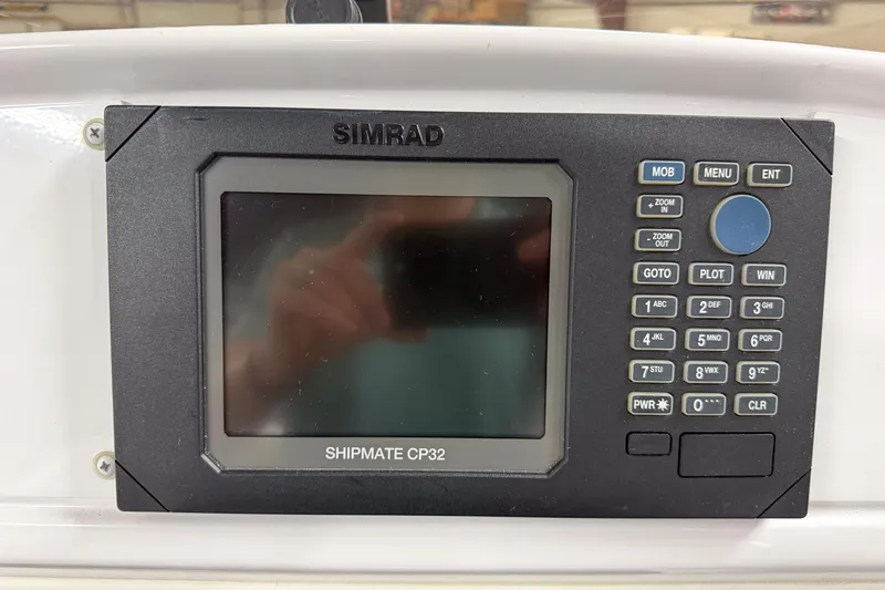 Slide: The Image of Simrad Shipmate CP32 navigation system on a 2002 Donzi 38 ZX boat dashboard. - 14