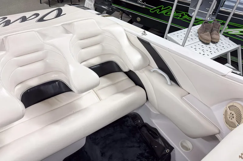 Slide: The Image of 2002 Donzi 38 ZX boat interior with white leather seats and speaker detail. - 20