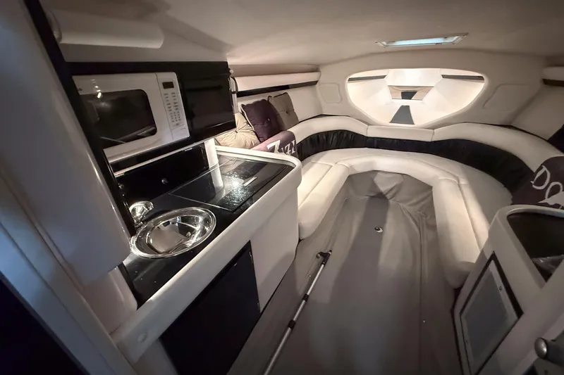 Slide: The Image of Interior of 2002 Donzi 38 ZX boat with kitchenette and seating area. - 22
