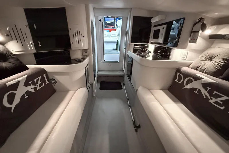 Slide: The Image of Interior of a 2002 Donzi 38 ZX boat with modern amenities and seating. - 23