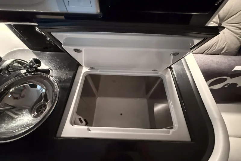 Slide: The Image of Open storage compartment and sink in 2002 Donzi 38 ZX boat interior. - 24