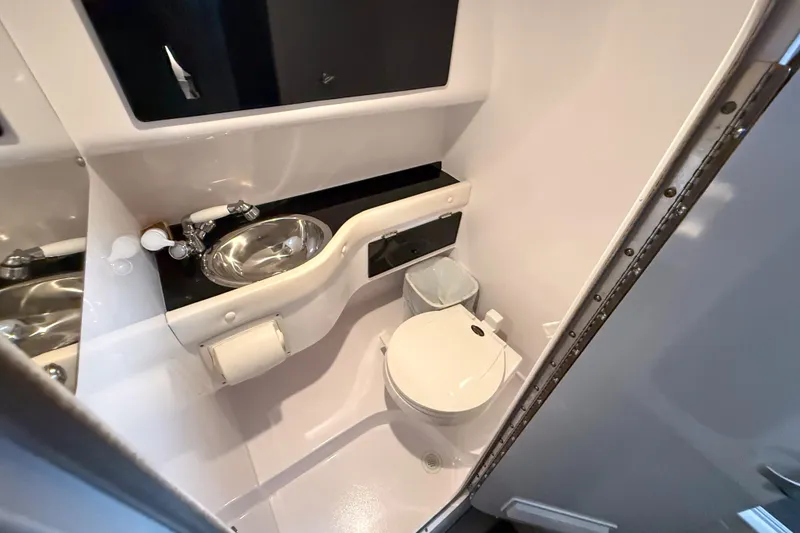 Slide: The Image of 2002 Donzi 38 ZX boat bathroom with sink, toilet, and mirror. - 33