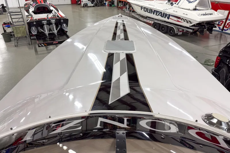 Slide: The Image of 2002 Donzi 38 ZX boat in a showroom with other performance boats. - 6