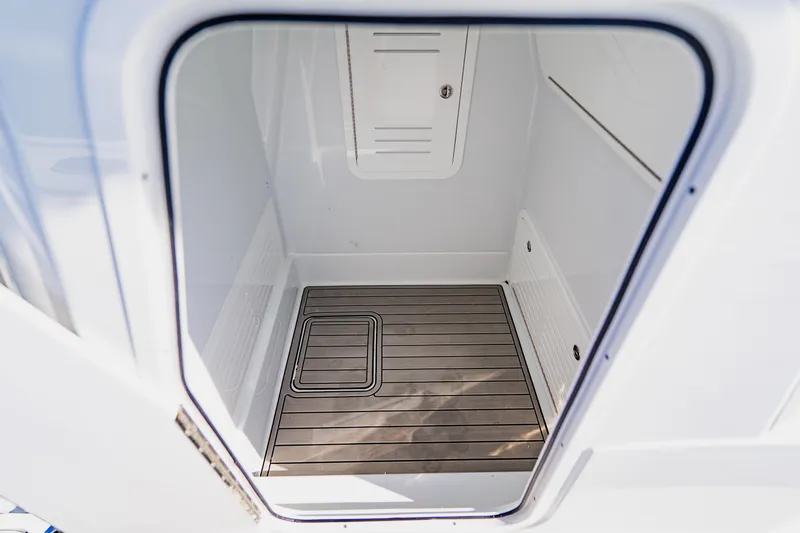 Slide: The Image of 2025 Yellowfin 36 Offshore boat interior compartment with wooden flooring. - 19