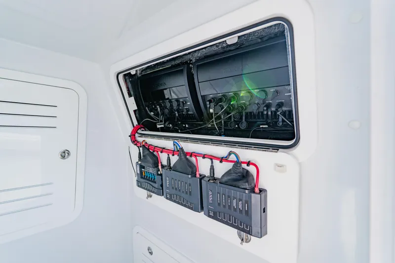 Slide: The Image of Electrical panel inside 2025 Yellowfin 36 Offshore boat, showcasing wiring and components. - 23