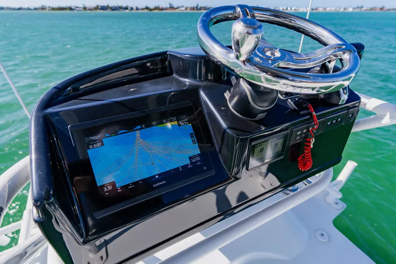 Slide: The Image of 2025 Yellowfin 36 Offshore boat dashboard with navigation display and steering wheel. - 25