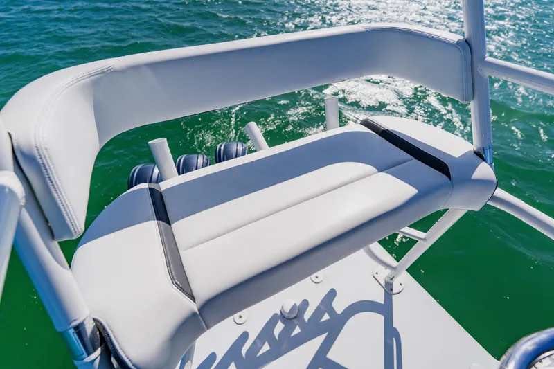 Slide: The Image of 2025 Yellowfin 36 Offshore boat seat with ocean view and sunlight reflections. - 26