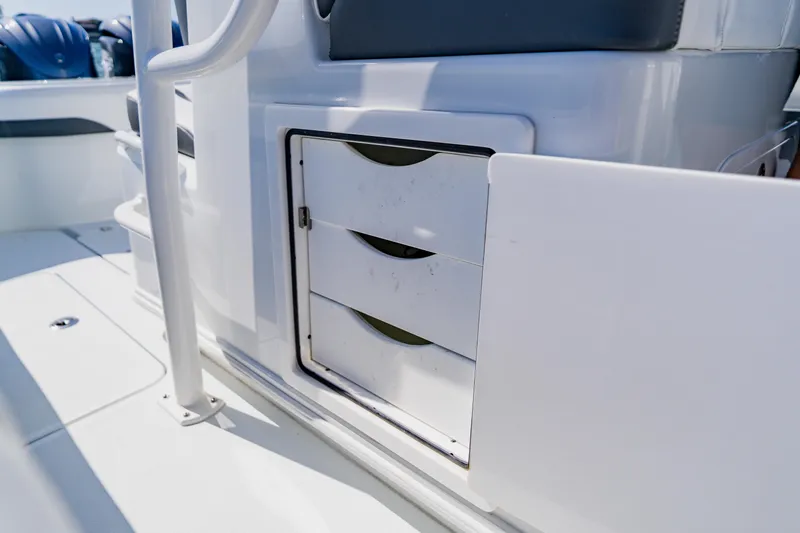 Slide: The Image of 2025 Yellowfin 36 Offshore boat storage compartment with drawers, open on deck. - 35